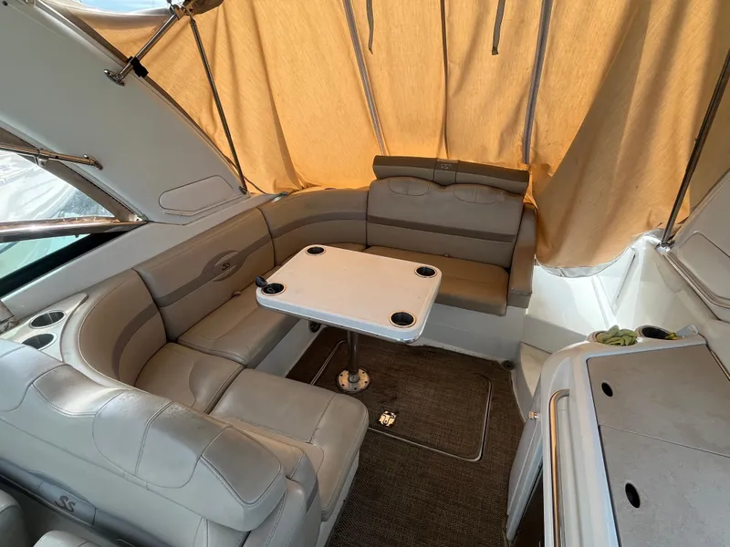 Slide: The Image of 2011 Formula 310 Sun Sport boat interior with beige seating and table. - 13