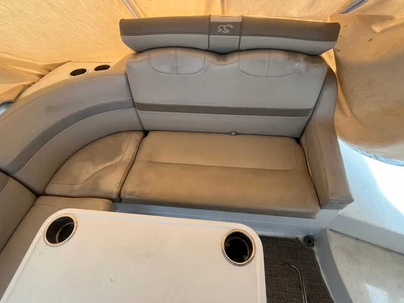 Slide: The Image of 2011 Formula 310 Sun Sport boat interior with gray seating and table. - 14