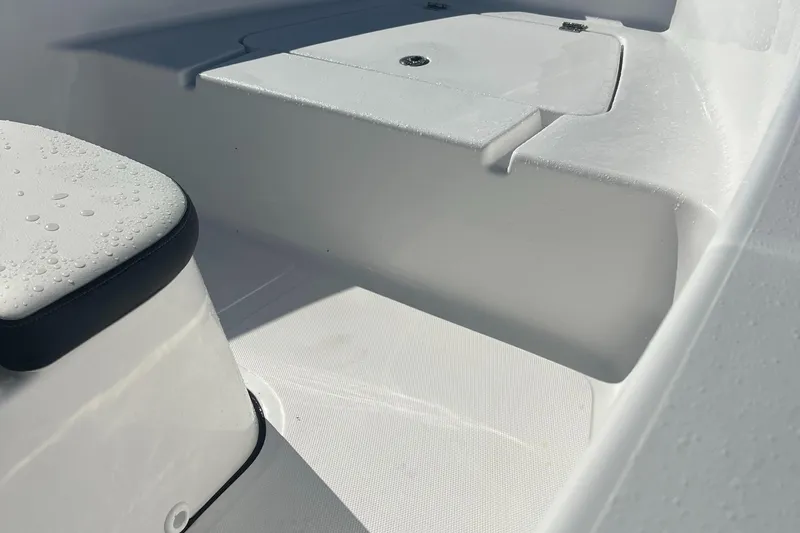 Slide: The Image of 2025 Tidewater 180 CC Adventure boat interior with seating and storage. - 12