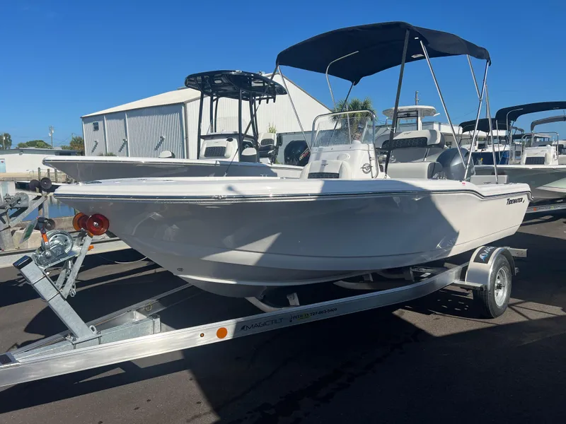 Slide: The Image of 2025 Tidewater 180 CC Adventure boat on trailer, featuring a sleek design and canopy. - 2