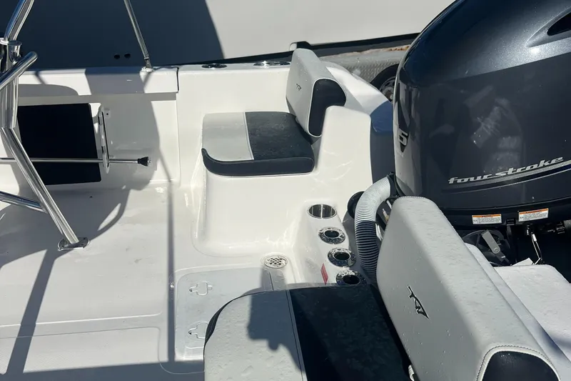 Slide: The Image of 2025 Tidewater 180 CC Adventure boat interior with seating and four-stroke engine. - 9