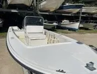Slide: The Image of 1970 Mako 17 CC boat in storage, white hull, center console design. - 10