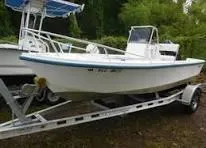 Slide: The Image of 1970 Mako 17 CC boat on trailer, white hull, outdoor setting. - 11