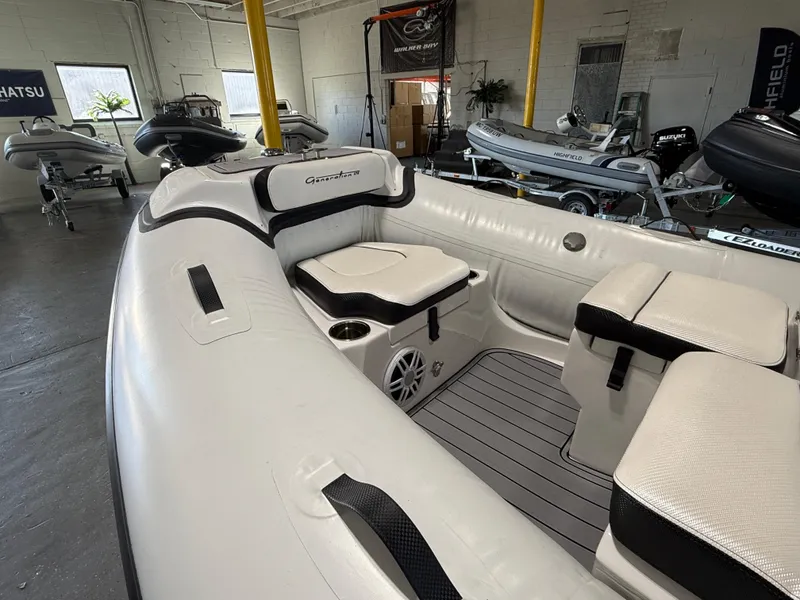 Slide: The Image of 2025 Walker Bay Generation 13 LTE boat interior with cushioned seating and modern design. - 10