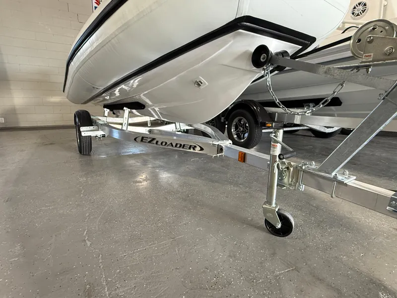 Slide: The Image of 2025 Walker Bay Generation 13 LTE boat on EZ Loader trailer in garage. - 11