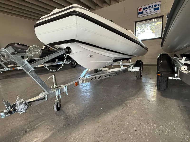 Slide: The Image of 2025 Walker Bay Generation 13 LTE boat on trailer in showroom. - 12