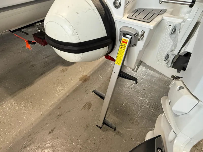 Slide: The Image of Walker Bay Generation 13 LTE 2025 boat with motor and support stand. - 13