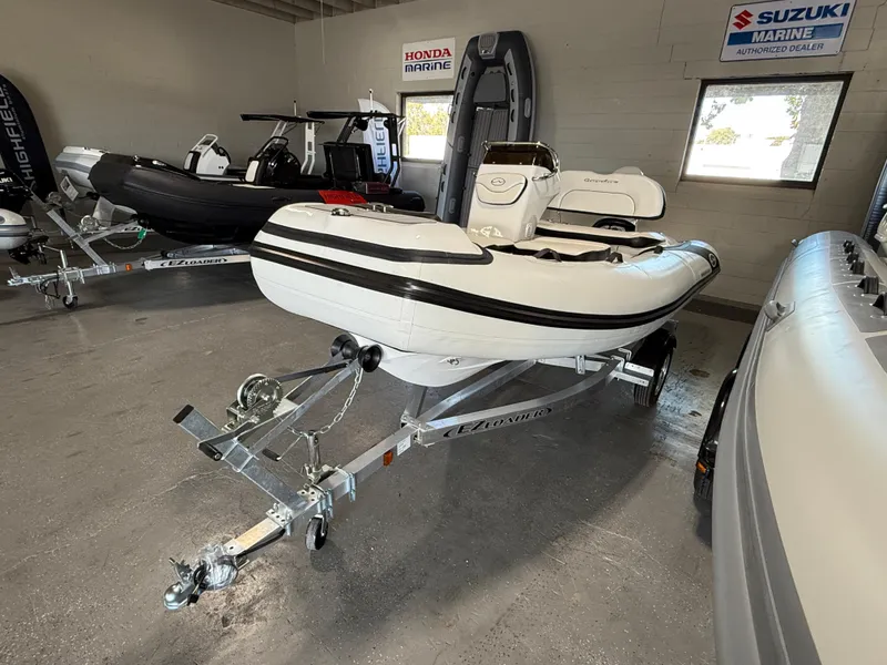 Slide: The Image of 2025 Walker Bay Generation 13 LTE inflatable boat on trailer in showroom. - 4