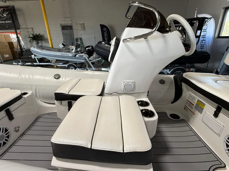 Slide: The Image of 2025 Walker Bay Generation 13 LTE boat interior with seating and steering console. - 7