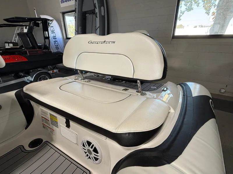 Slide: The Image of 2025 Walker Bay Generation 13 LTE boat interior with cushioned seating and speaker. - 9