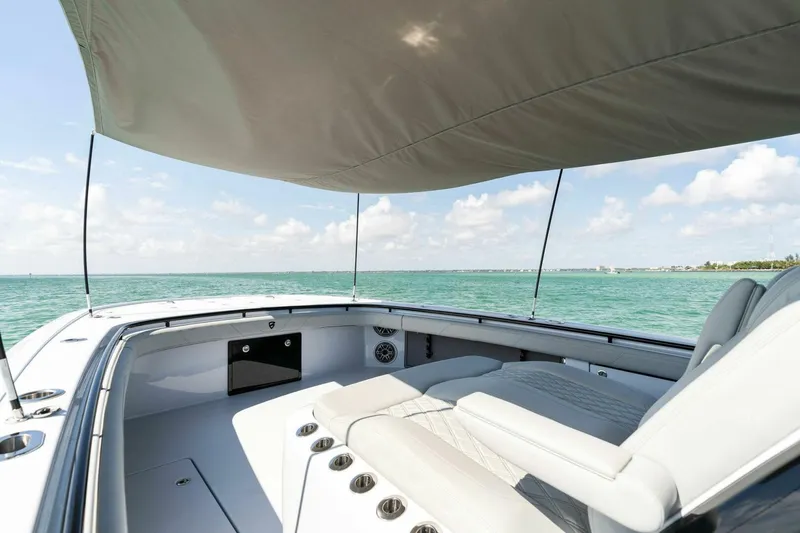 Slide: The Image of 2023 Barker Boatworks 40 High Performance Cat on open water, featuring spacious seating and canopy. - 13