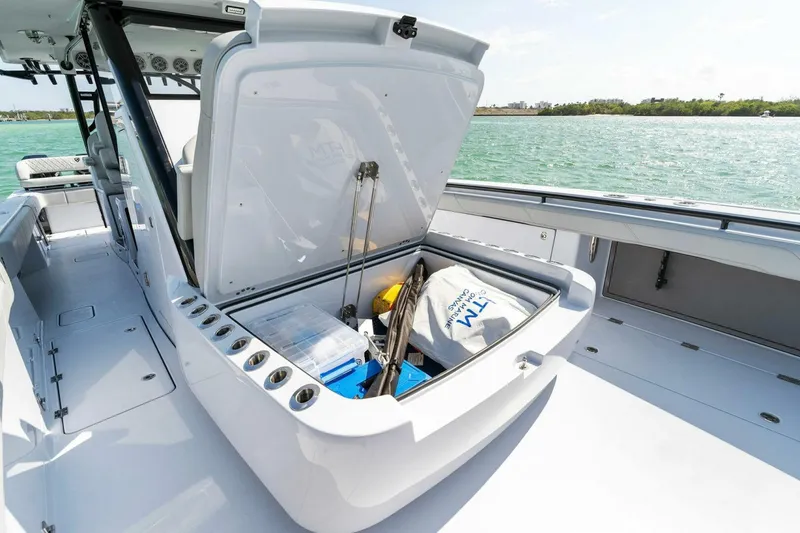 Slide: The Image of 2023 Barker Boatworks 40 High Performance Cat with open storage compartment on deck. - 16