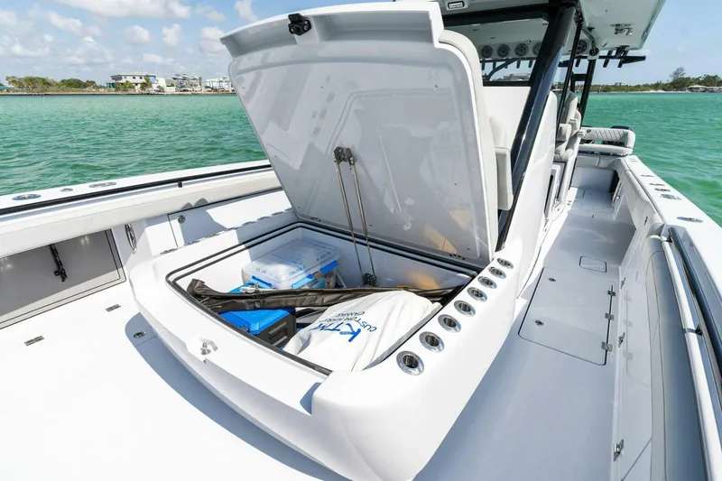 Slide: The Image of 2023 Barker Boatworks 40 High Performance Cat with open storage compartment on deck. - 18