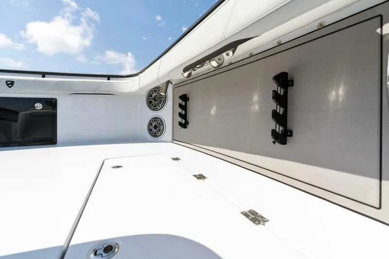 Slide: The Image of 2023 Barker Boatworks 40 High Performance Cat interior with storage and speakers. - 20