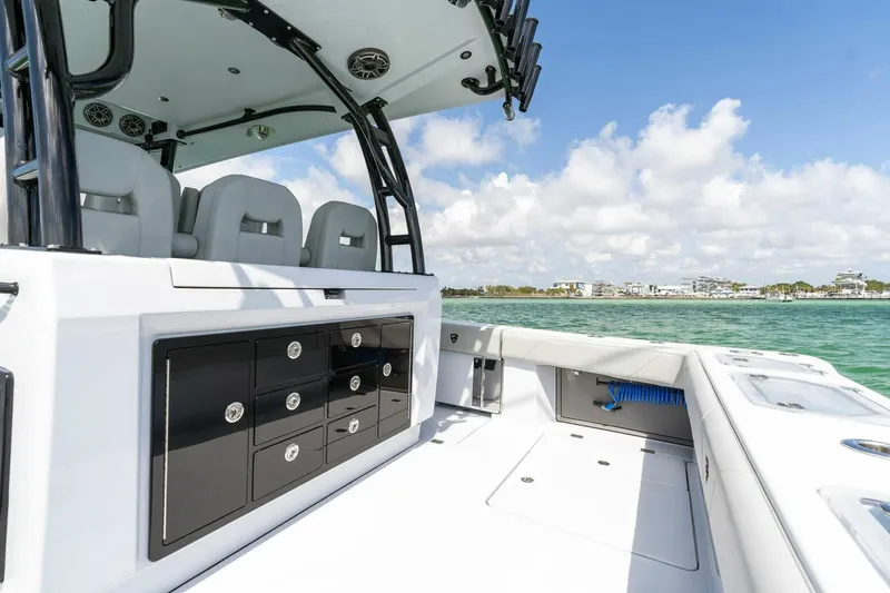Slide: The Image of 2023 Barker Boatworks 40 High Performance Cat interior with seating and storage, ocean view. - 23