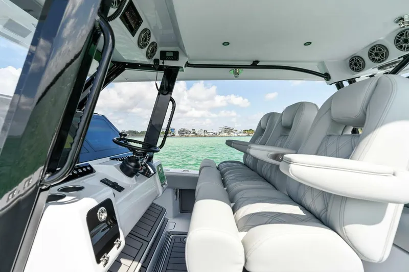 Slide: The Image of 2023 Barker Boatworks 40 High Performance Cat interior with luxurious seating and modern controls. - 25