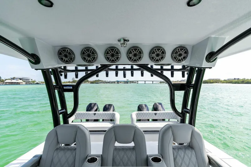 Slide: The Image of 2023 Barker Boatworks 40 High Performance Cat interior with speakers and seating, overlooking water. - 26