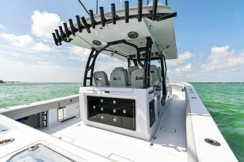 Slide: The Image of 2023 Barker Boatworks 40 High Performance Cat on clear water, showcasing spacious deck and seating. - 34