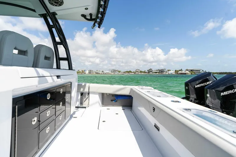 Slide: The Image of 2023 Barker Boatworks 40 High Performance Cat on water, featuring spacious deck and Mercury engines. - 37