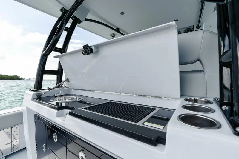 Slide: The Image of 2023 Barker Boatworks 40 High Performance Cat, featuring a sleek onboard kitchen setup. - 38