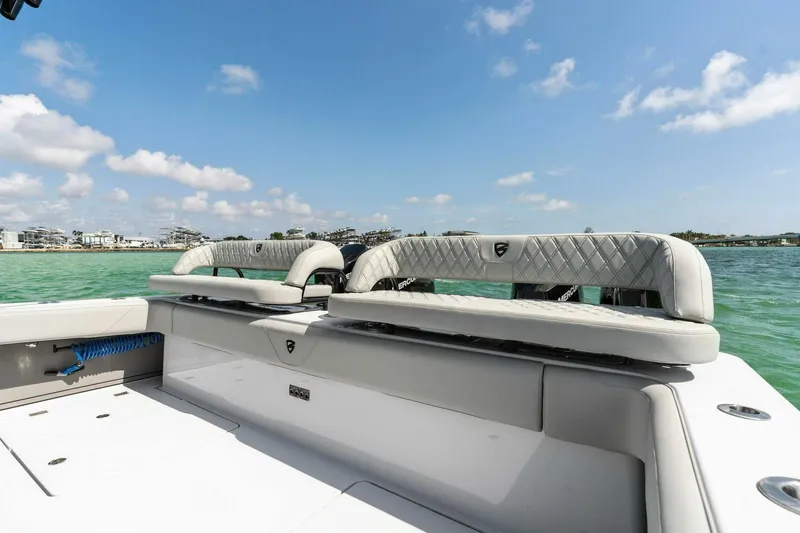 Slide: The Image of 2023 Barker Boatworks 40 High Performance Cat on water, featuring luxurious seating. - 5