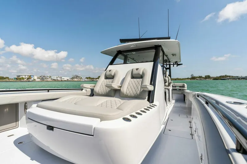 Slide: The Image of 2023 Barker Boatworks 40 High Performance Cat on water, showcasing luxury seating and sleek design. - 6