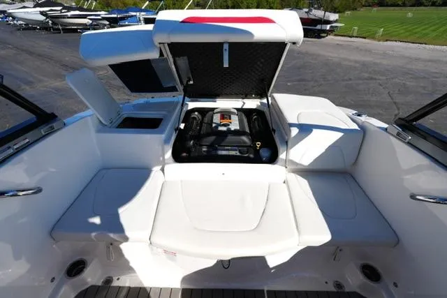 Slide: The Image of 2016 Chaparral H20 19 boat engine compartment with open hatch, showcasing interior details. - 13