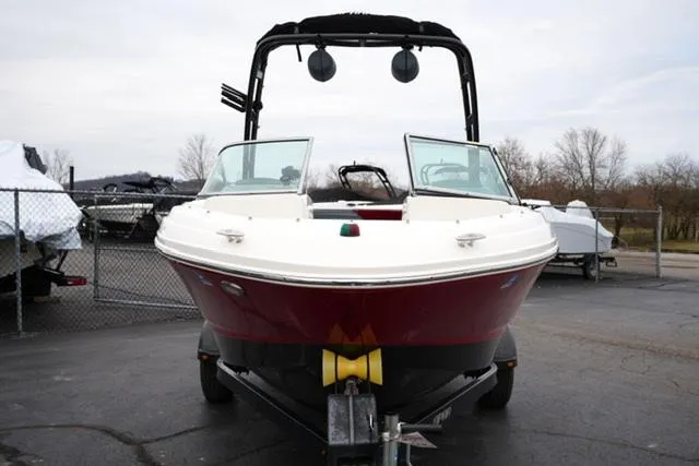 Slide: The Image of 2016 Chaparral H20 19 boat on trailer, red and white, parked outdoors. - 16