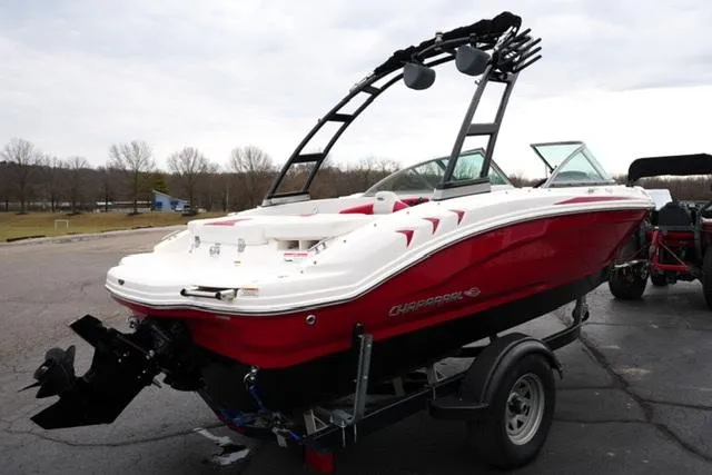 Slide: The Image of 2016 Chaparral H20 19 boat on trailer, red and white design, parked outdoors. - 19