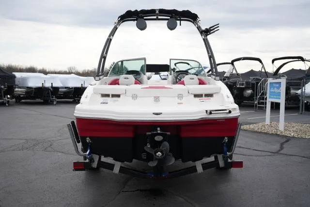 Slide: The Image of 2016 Chaparral H20 19 boat, rear view, parked on a trailer in a lot. - 20