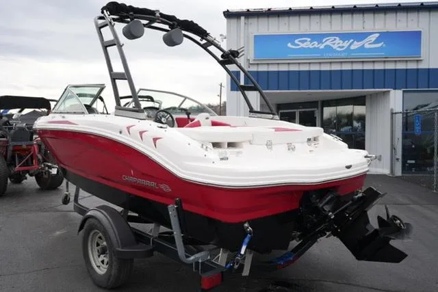Slide: The Image of 2016 Chaparral H20 19 boat, red and white, on trailer outside dealership. - 21