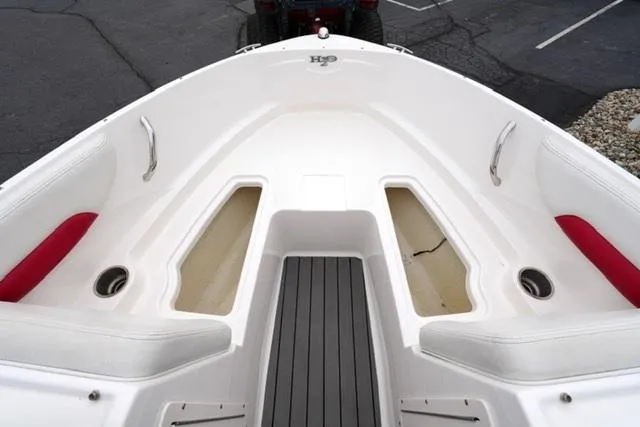 Slide: The Image of 2016 Chaparral H20 19 boat interior with red accents and storage compartments. - 24