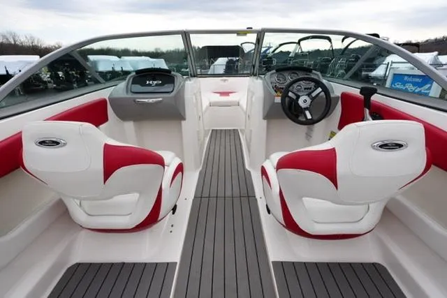 Slide: The Image of 2016 Chaparral H20 19 boat interior with red and white seating, modern dashboard. - 26