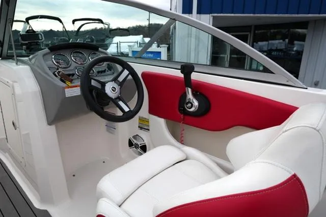 Slide: The Image of 2016 Chaparral H20 19 boat interior with red and white seating, steering wheel, and controls. - 27
