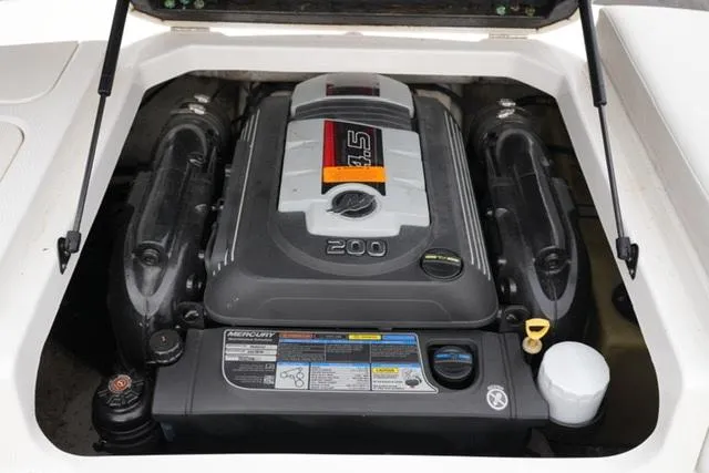 Slide: The Image of 2016 Chaparral H20 19 boat engine compartment with Mercury 4.5L 200 HP engine. - 32