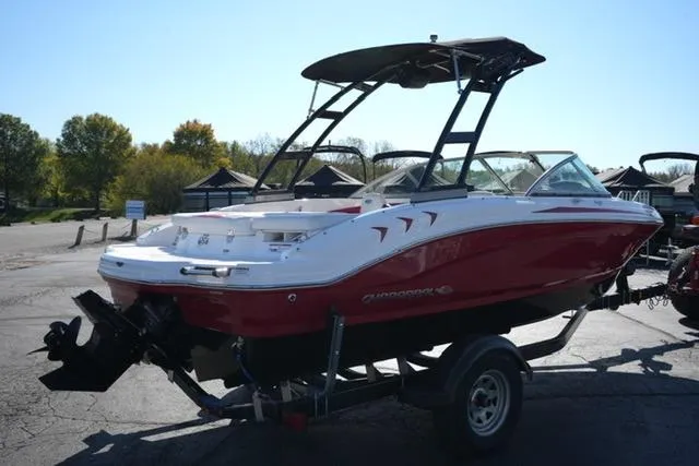 Slide: The Image of 2016 Chaparral H20 19 boat with red and white exterior on a trailer. - 4