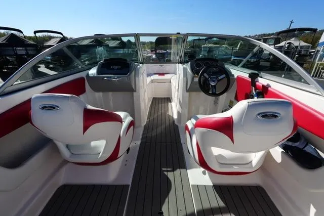 Slide: The Image of 2016 Chaparral H20 19 boat interior with red and white seating, steering wheel, and dashboard. - 7
