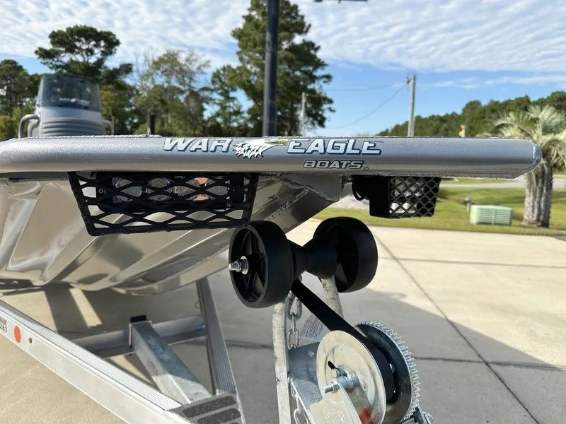 Slide: The Image of 2025 War Eagle Blackhawk 961 boat on trailer, outdoor setting. - 11