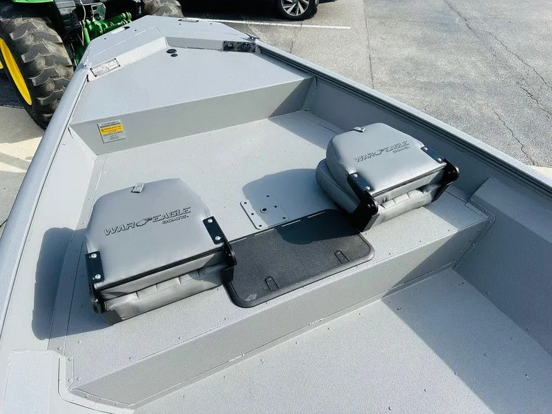 Slide: The Image of 2025 War Eagle Blackhawk 961 boat interior with seating and storage compartments. - 4