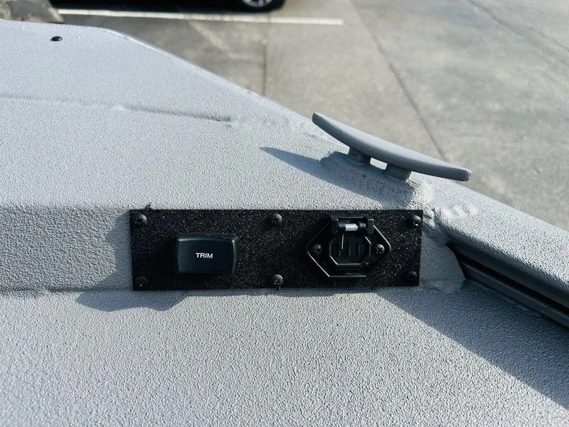 Slide: The Image of 2025 War Eagle Blackhawk 961 boat dashboard with trim control and accessory port. - 5