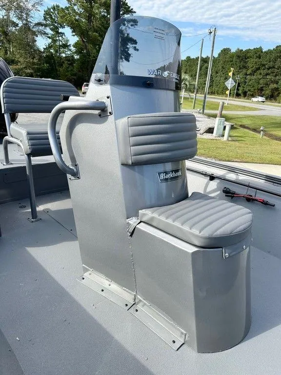 Slide: The Image of 2025 War Eagle Blackhawk 961 boat console with seating, outdoors. - 6