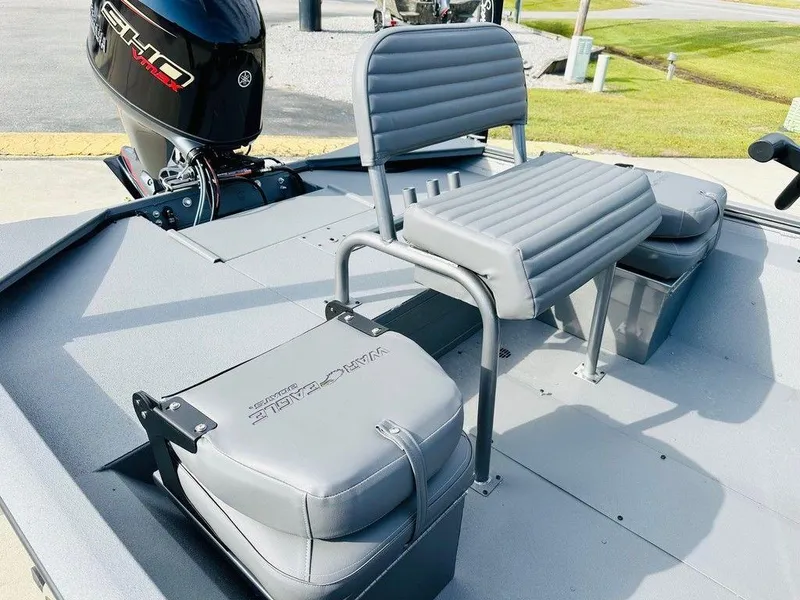 Slide: The Image of 2025 War Eagle Blackhawk 961 boat interior with gray seating and motor. - 8