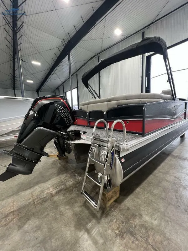 Slide: The Image of 2023 Premier 250 Intrigue RF pontoon boat in a spacious indoor showroom. - 10