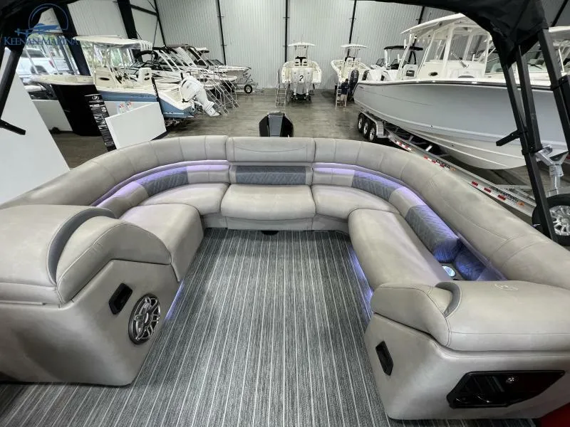 Slide: The Image of Luxurious interior of 2023 Premier 250 Intrigue RF pontoon boat with plush seating and ambient lighting. - 12
