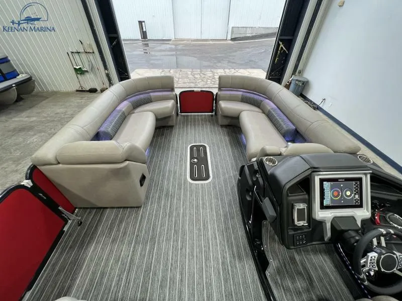 Slide: The Image of 2023 Premier 250 Intrigue RF pontoon boat interior with plush seating and modern dashboard. - 15