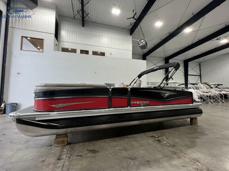 Slide: The Image of 2023 Premier 250 Intrigue RF pontoon boat in a spacious indoor showroom. - 3
