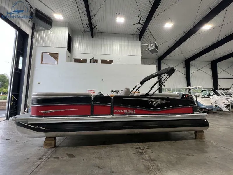 Slide: The Image of 2023 Premier 250 Intrigue RF pontoon boat in a spacious indoor showroom. - 6