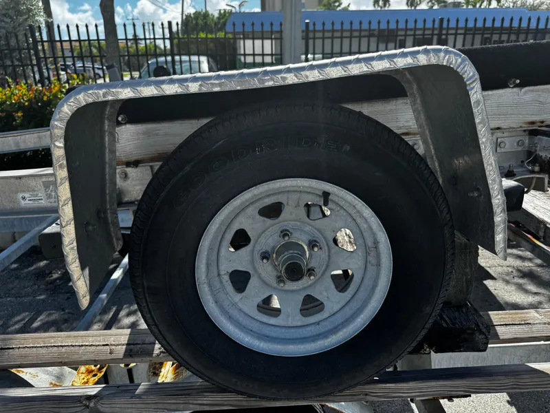 Slide: The Image of 2020 BOAT MASTER trailer wheel with metal fender in parking lot. - 6