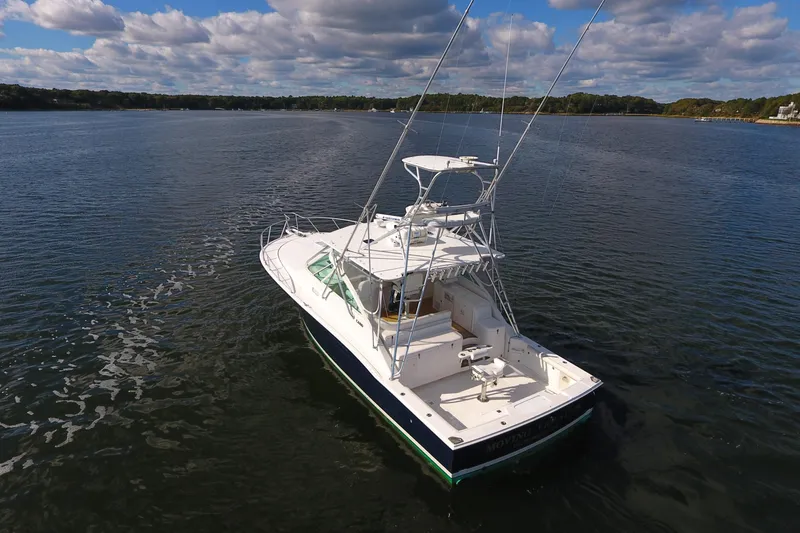 Slide: The Image of 2008 Cabo 40 boat on calm water under a partly cloudy sky. - 11