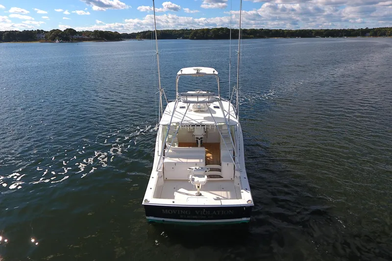 Slide: The Image of 2008 Cabo 40 boat on calm water under a partly cloudy sky. - 12